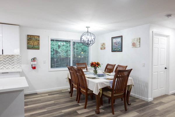 Dining table with chairs and a large window