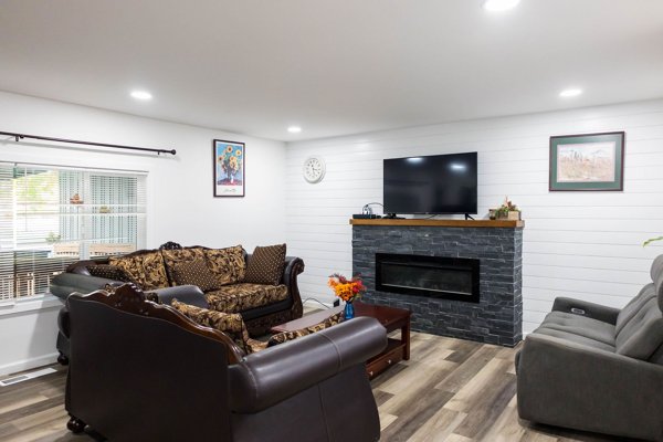 Living room with sofas, fireplace, and television